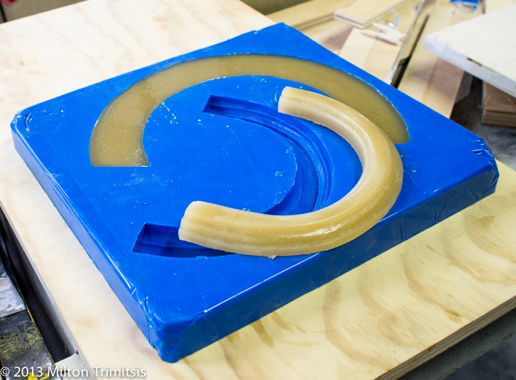 completed urethane casting of curved molding on top of silicone mold