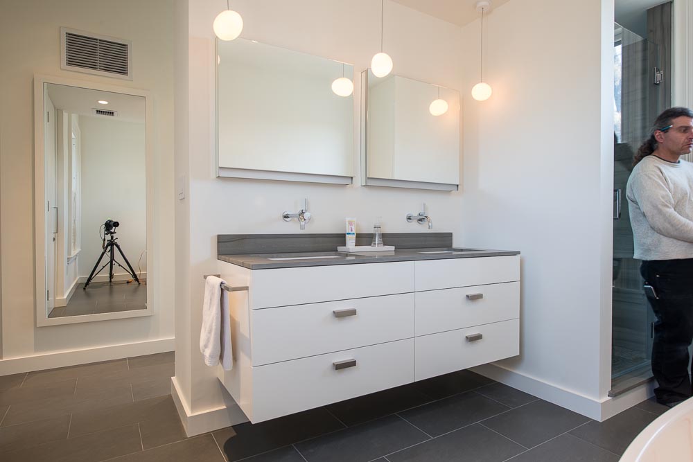 Custom vanity cabinet with camera and photographer visible in background