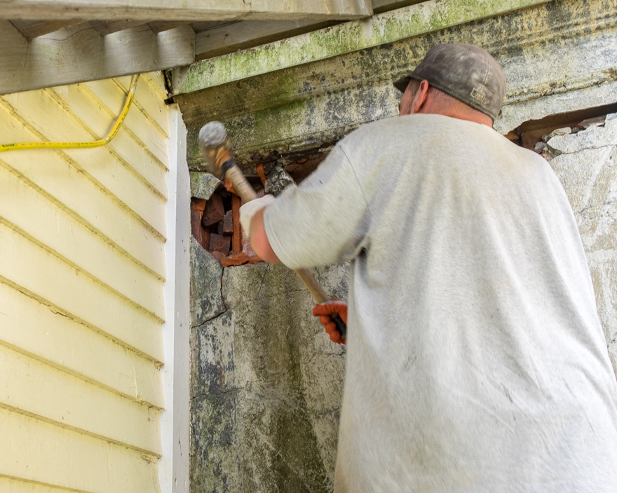 Demolishing concrete and terra-cotta block wall