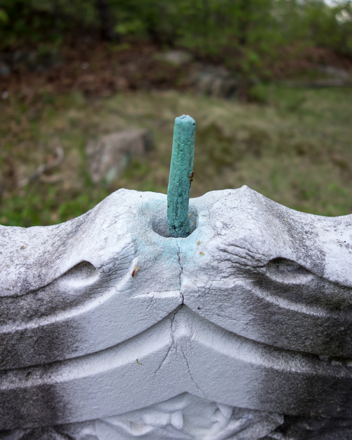 Copper spike at top of marble gravestone